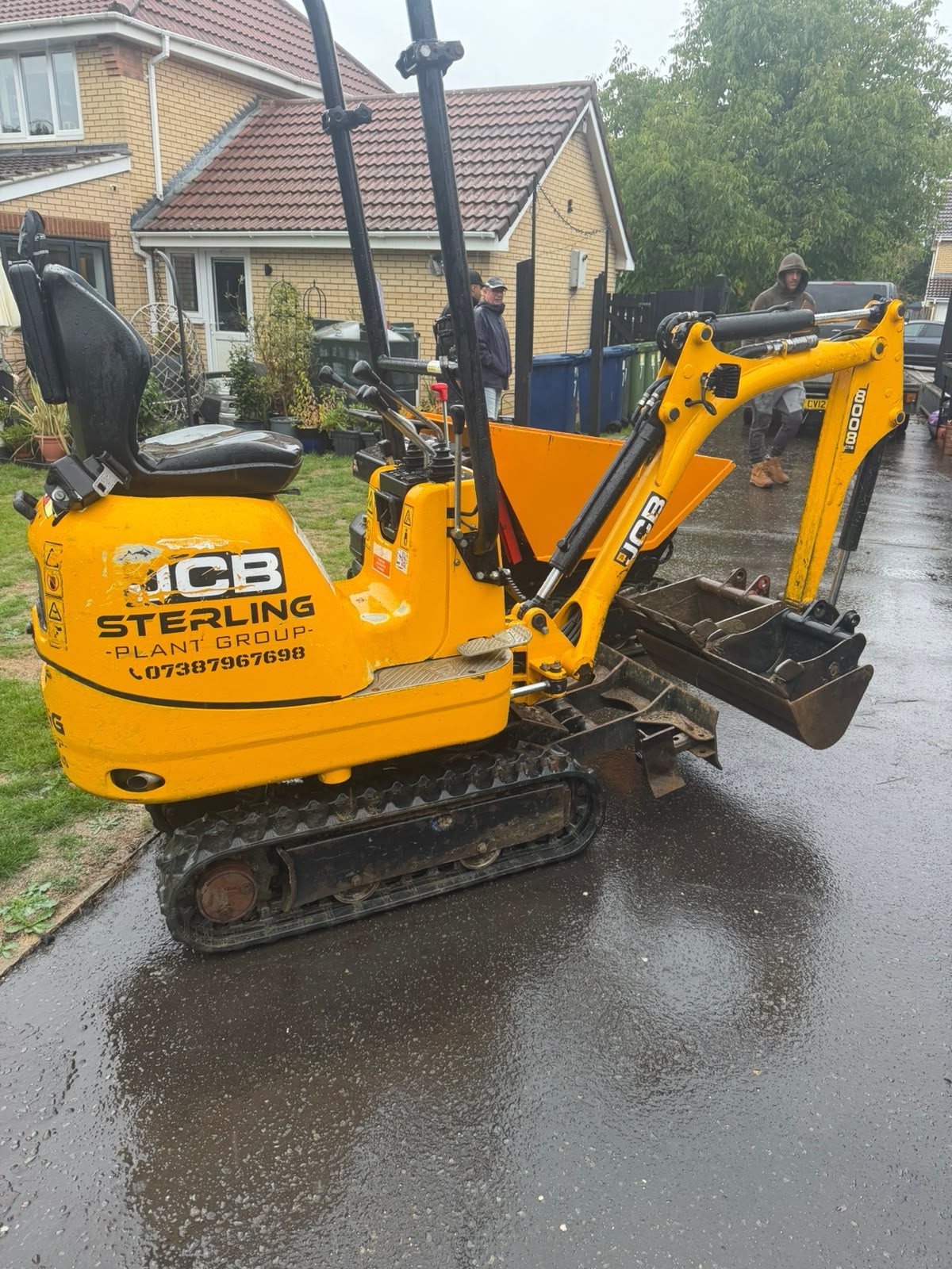 Sterling-branded JCB 8008 CTS micro digger and yellow tracked dumper together on a customer driveway